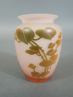 a glass vase with a gold leaf design on it