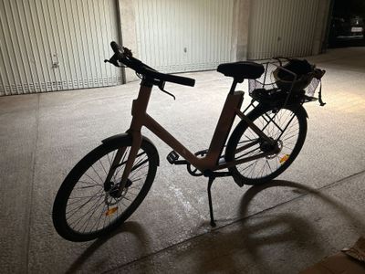 a bike parked in a garage with a basket on the back of it