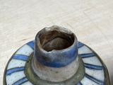 a small blue and white vase sitting on a table