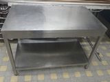 a stainless steel table with a shelf underneath it