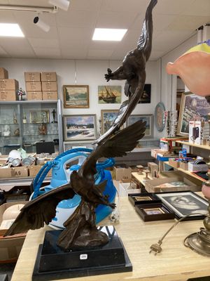 a statue of a bird on a table in a shop