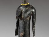 an image of a wooden statue of a man with a hat on his head
