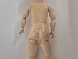 a wooden doll that is sitting on a white surface