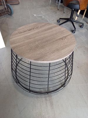 a round table with a wooden top in a room