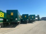 many trucks that are lined up on the side of the road