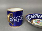 pair of royal blue and gold coffee cups and saucer