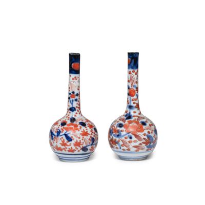pair of vases with floral designs on the sides of them