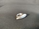 a silver ring sitting on top of a black surface