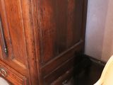 a chair that has a red seat in front of a cabinet