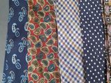 several different colored ties are lined up on a table