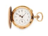 an old gold pocket watch with a white face on a white background