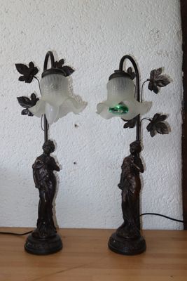 two lamps that are sitting on a table next to each other