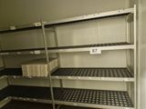 many shelves with baskets on them in a room