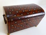 a small wooden box with a decorative design on it