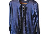 blue blouse with ruffles and buttons on a hanger