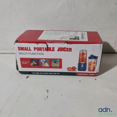a small portable juicer in the box on the table