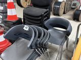 many chairs that are stacked up in a warehouse
