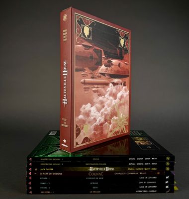 many books stacked on top of each other on a table