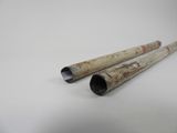 two wooden pipes sitting on top of a table next to each other