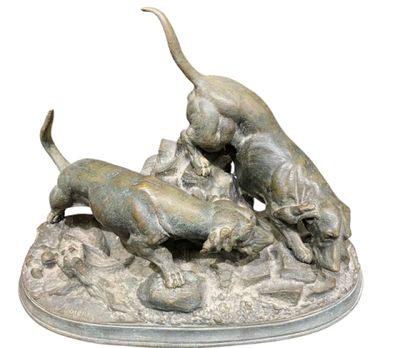 statue of a group of dogs playing with a ball on a rock