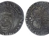 a silver coin with a cross on the front and a shield on the back
