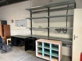 a room with a desk, shelves, and a chair in it