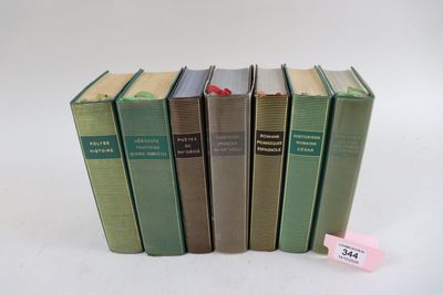 plusieurs livres sont empilés sur une surface blanche