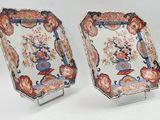 pair of chinese imarized plates on stands with flowers in vases