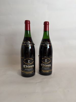 two bottles of wine sitting next to each other on a table