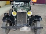 a old car that is parked in a garage
