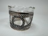 a silver cup with a snake on it on a table