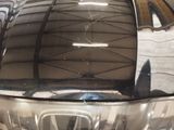 a reflection of a car in the rear of it ' s hood