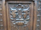 a wooden door with carvings on it in a room