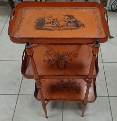 a wooden table with three trays on top of it