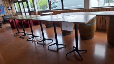 a long table with four chairs in front of a window