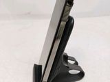 a close up of a cell phone on a stand on a table