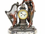 a statue of a woman holding a harp next to a clock