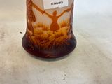 a glass vase with a picture of a man and a dog on it
