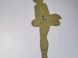a metal statue of a man on a cross on the wall