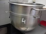 a large metal bowl sitting on top of a microwave oven