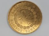 an image of a gold coin sitting on top of a white surface