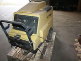 a yellow machine that is sitting on a pallet
