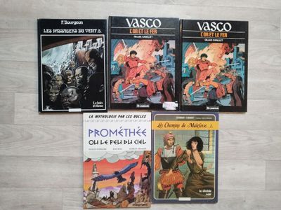 four books that are sitting on the floor together