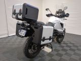 a motorcycle that is parked in a room with a black and white checkered floor