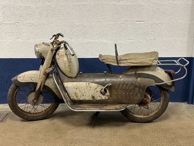 an old motorcycle that is parked in a garage