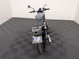 a motorcycle that is parked in a room with a checkered floor