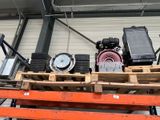 many different types of air compressors on a pallet in a warehouse