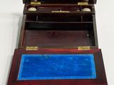 a small wooden box with a blue tray inside of it