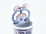 a blue and white vase with a decorative design on it