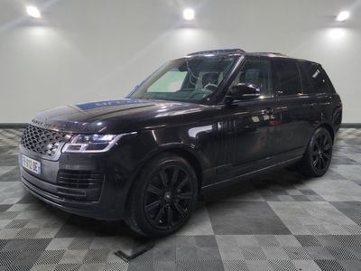 the black range rover is parked on a checkered tile floor
